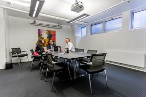 a group of people sitting around a table in an office at ProfilHotels Mercur in Copenhagen