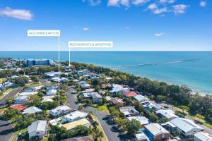 an aerial view of a city with houses and the ocean at The Springs Villa 2 in Urangan +17 photos