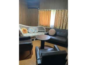 a living room with a couch and a table and chairs at Kominka Nagomi Guest House - Vacation STAY 19240 in Miyazu