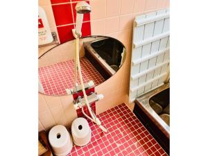 a bathroom with a mirror and a red tiled floor at Kominka Nagomi Guest House - Vacation STAY 19240 in Miyazu +13 photos