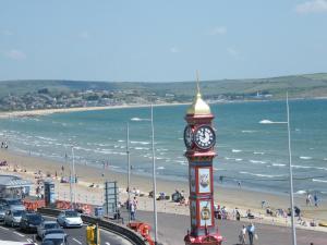 a clock tower on the side of a beach at Weymouth Beach B&B - Adult Only in Weymouth