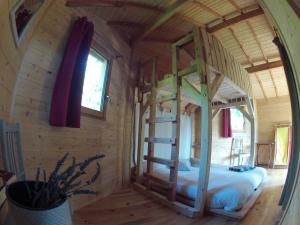 a wooden room with two bunk beds in it at Ô Bois Dormant in Lempzours