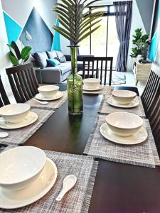 a dining room table with plates and spoons on it at Bukit Indah 12pax Aeon Lego Wi-fi Netflix BySTAY in Johor Bahru