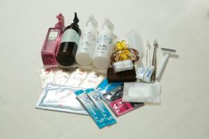 the contents of a bag are laid out on a table at HOTEL & SPA J-MEX Shinjuku Kabukicho (Adult Only) in Tokyo