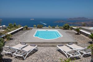 a swimming pool with two lounge chairs and a pool at Ananda Retreat in Megalokhori