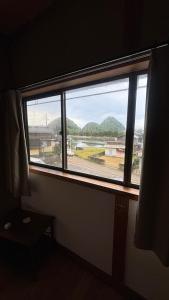 a window in a room with a view of a field at Waterside Japanese House Villa 一棟貸し 30名OK キッズルーム in Toyooka +16 photos