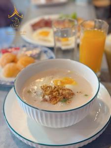 a bowl of soup on a plate on a table at Mueang Nuea Boutique Hotel in Luang Prabang