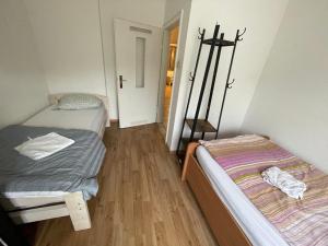 a small room with two beds and a hallway at MAD Ferienwohnungen 1 in Dortmund