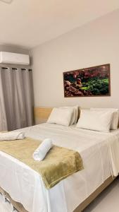 a bedroom with two beds with white sheets at Pousada Capivara Express in Baixas