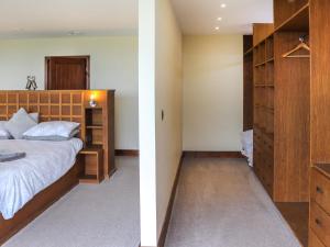 a bedroom with a bed and a closet at Snowdon Summit View in Llanllyfni