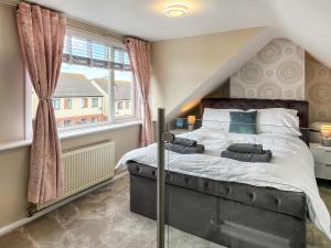 a bedroom with a large bed and a window at Lawsons Lodge in Whitby