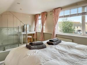 a bedroom with a large bed with two pillows on it at Lawsons Lodge in Whitby