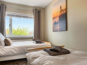 two beds in a room with a window at Lawsons Lodge in Whitby