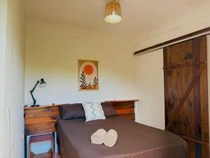 a bedroom with a bed with two hats on it at Casa OMI in Brisas de Zicatela