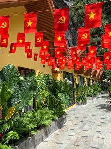 a row of red flags hanging from a building at For You Ninh Bình Boutique in Ninh Binh