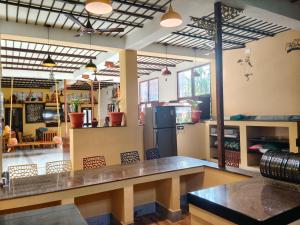 a large kitchen with a counter and a refrigerator at Maha Periyava Kuteeram in Kumbakonam