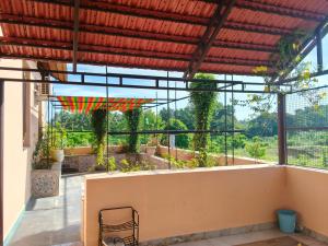 a view from the balcony of a house with an umbrella at Maha Periyava Kuteeram in Kumbakonam