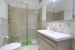 a bathroom with a shower and a sink and a toilet at Marea Sicula in Siracusa