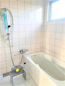 a white bathroom with a tub and a shower at Ie shima-MONKEY - Vacation STAY 48431v in Ie +18 photos