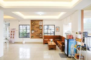 a lobby of a store with a bench and a table at RedDoorz near Taman Rekreasi Selecta in Malang