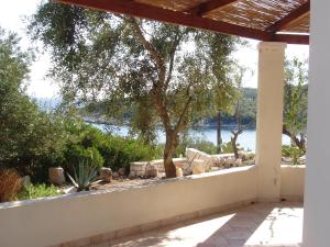 a porch with a view of the water at Nereidi Villas in Porto Ozias