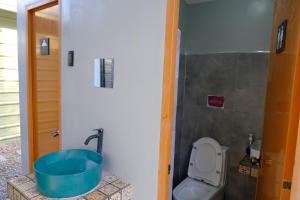 a bathroom with a toilet and a bath tub at Camp Felicidad in Talisay +20 photos