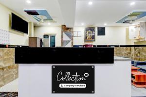 a lobby with a sign for a store at Super Collection O Khajaguda Hills Formerly Sri Balaji Luxary Rooms in Gachibowli