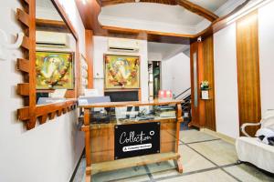 a salon with a counter and paintings on the wall at Super Collection O Sharath City Mall Formerly Delight Inn Gachibowli in Kondapur