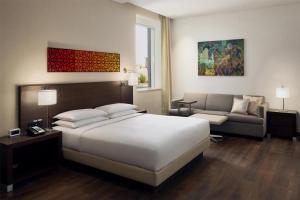 a hotel room with a bed and a couch at Hyatt Place Riyadh Sulaimania in Riyadh
