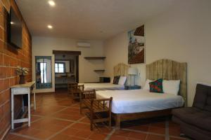 a living room with two beds and a couch at Hotel Finca San José in Teotlalco