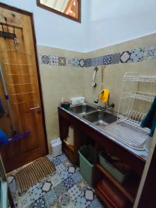 a small kitchen with a sink and a wooden door at VidFauw Oasis Villa in Naamlong +66 photos