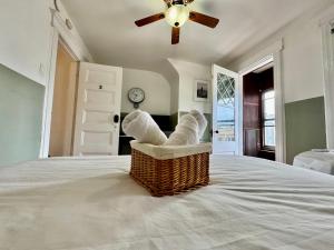 a bedroom with a bed with a fan and a chair at 20 min NYC-Modern Private Room-Queen Bed-Parking in Jersey City