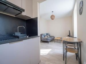 a kitchen with a counter and a table in a room at La Dolce Vita in Évian-les-Bains