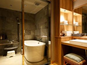 a bathroom with a tub and a sink and a shower at Yumekaiyu Awajishima in Sumoto +69 photos