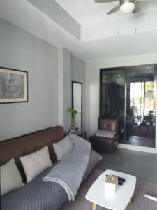 a living room with a couch and a table at Mamay's Place Barkada Room in Tagbilaran City