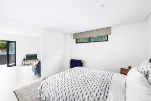 シドニーにあるKINGS10V - Luxe at Kingsのベッドと窓のある白い寝室