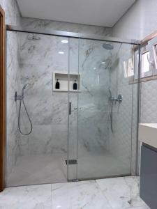 a shower with a glass door in a bathroom at Hotel Santos Silva in São Tomé +39 photos