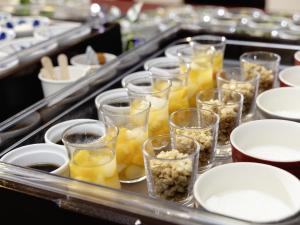 a buffet line with glasses of food and plates at KOKO HOTEL Tokyo Nishikasai in Tokyo