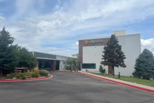 a large building with a road in front of it at La Quinta by Wyndham Denver Englewood Tech Ctr in Greenwood Village