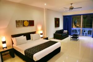 a bedroom with a bed and a living room at East Suites in Pattaya South