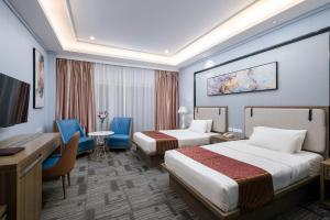 a hotel room with two beds and a desk at Sunlight Hotel Puerto Princesa in Puerto Princesa City +17 photos