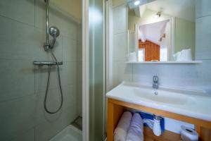 a bathroom with a sink and a shower at Auberge des Montauds - Hôtel & Restaurant in Villard-de-Lans +29 photos
