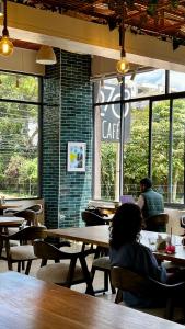 a person sitting at a table in a cafe at Marina Bay One & Two Bedroom Apartment, Swimming pool, gym, workspace ,Wonderiss Homes Westland Living in Nairobi