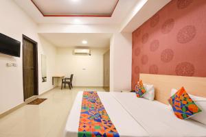 a hotel room with a bed and a table at FabHotel Blue Stone in New Delhi +19 photos