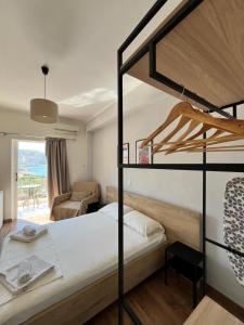 a bedroom with a bunk bed and a couch at Duka Rooms in Himare