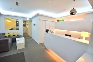 
a kitchen with a white counter top and white cabinets at Inn Cube - Ximen in Taipei
