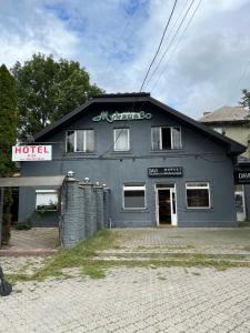 a large gray building with a hotel sign on it at Hotel Мукачево in Mukacheve