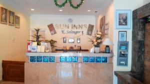 a store front with a counter with blue tiles at Sun Inns Hotel Kuala Selangor in Kuala Selangor