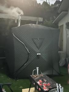 a large grill in a yard with a table at FLORAhouse in Oita