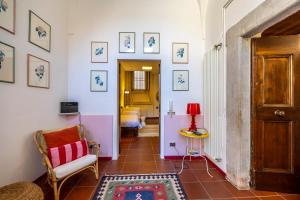 a hallway with a chair and a table with a lamp at Cozy Corner in Brescia Center - Dogeshouse in Brescia